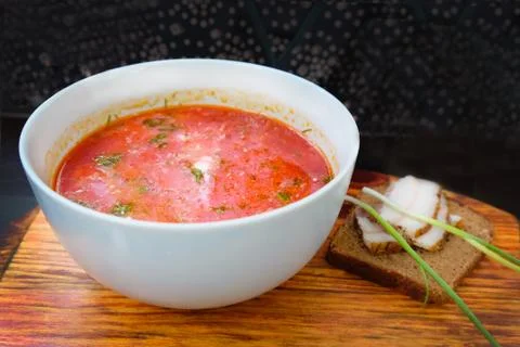 A plate with a red borscht on the table close-up. Lunch menu borscht with sou Stock Photos