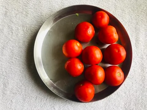 Plate of red tomatoes Stock Photos
