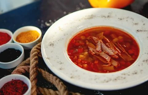 Plate of red vegetable soup with beef slices Stock Photos