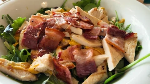 On a plate in a restaurant Caesar salad, delicious chicken salad with herbs. Stock Footage 317763560