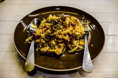 A plate of rice with a fork and spoon on it Stock Photos