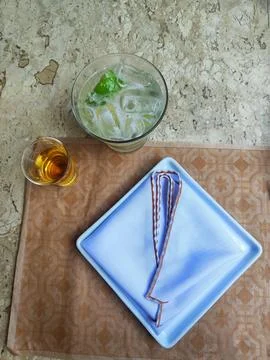 Plate set on the table for dinner with glasses of drinks Stock Photos