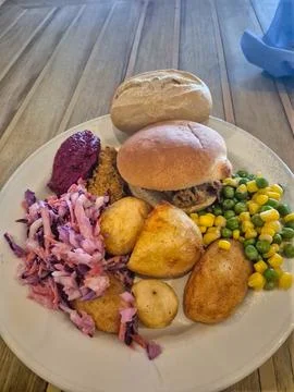 Plate of sliced bread with vegetables and hash brown potatoes Stock Photos