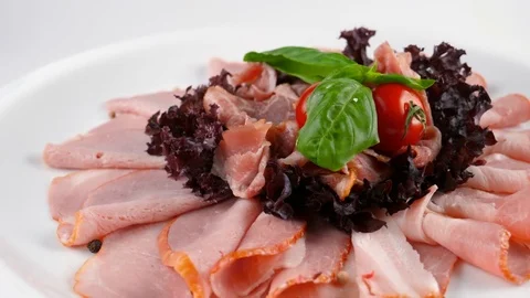 Plate with sliced ham and jamon on top Stock Footage 84262693