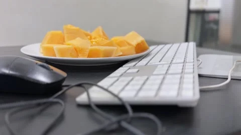 Plate of sliced melon on modern office desk Stock Footage 336763864