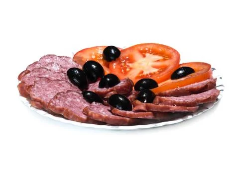 Plate of sliced sausage, tomato and olives on white background Stock Photos