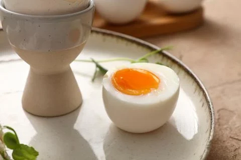 Plate with soft boiled egg and micro green on beige background, closeup Stock Photos