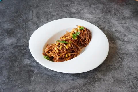 A plate of spaghetti with meat and vegetables Stock Photos