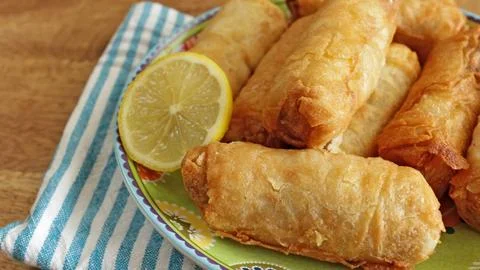 Plate of spring rolls, close-up, on a table Stock Photos