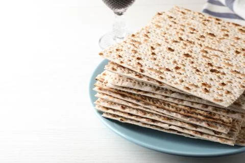 Plate with stack of matzos on white table 스톡 사진