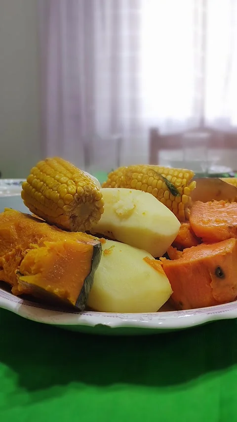 A plate of steamed vegetables including corn, pumpkin, sweet potato, and po.. Stock Footage 291536849