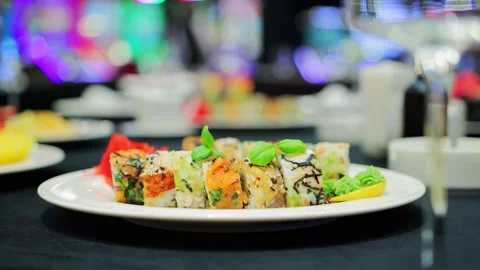 Plate on the table with different rolls with wasabi and sesame on the table in a Stock Footage 297255127