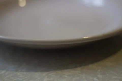 Plate on table. Empty plate in kitchen. Dishes for eating. Stock Photos