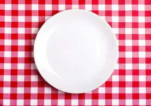 Plate on a tablecloth Stock Photos