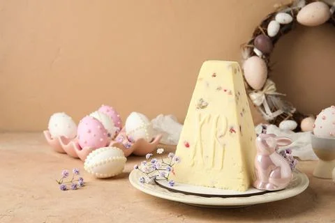 Plate with tasty curd Easter cake, ceramic bunny, gypsophila flowers and eggs Stock Photos