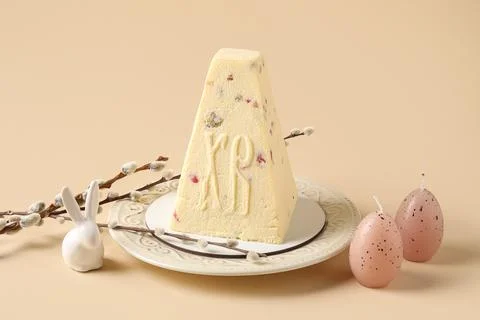Plate with tasty curd Easter cake, candles in shape of eggs, ceramic bunny an Stock Photos