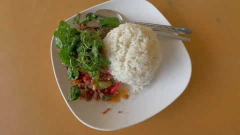 A plate of Thai holy basil fried with minced beef and rice. Stock Footage 276850323