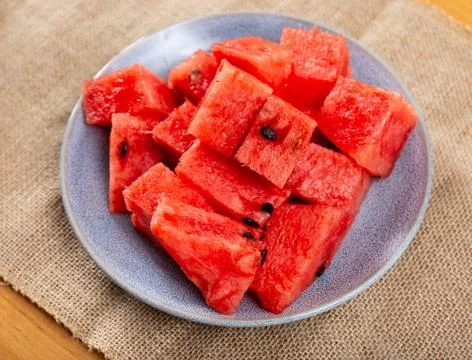 In plate there is small portion of watermelon pulp, useful cubes Stock Photos