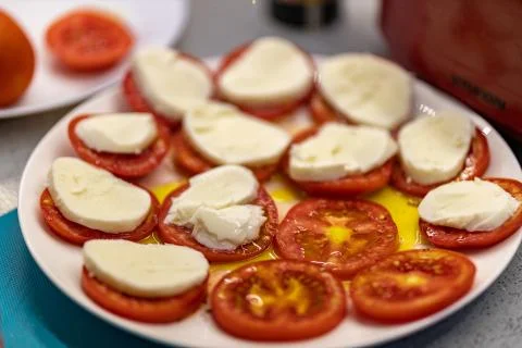 A plate of tomatoes with cheese Stock Photos