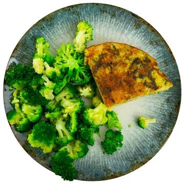 On plate is triangular piece of omelet with asparagus flecks, garnished with Stock Photos
