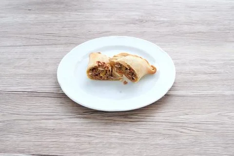 A plate with two burritos on it Stock Photos