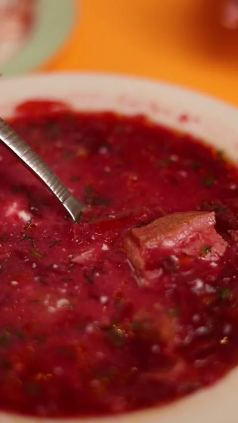 A plate of Ukrainian borsch on an orange background Stock Footage 264948255