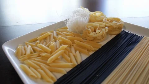 Plate with various types of dry pasta. the camera flies over it backwards Stock Footage 121406996