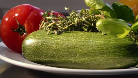 A plate on which there is a zucchini pepper onion garlic tomato Stock Footage 157981546