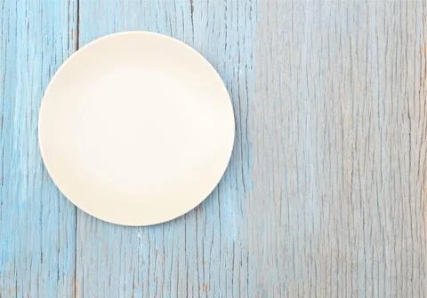 Plate on wood table background Stock Photos