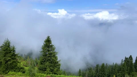 The plateau is covered with clouds that move over the mountain valley.  Stock Footage 284423988
