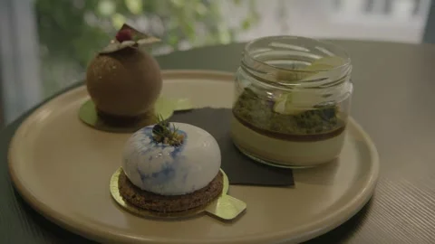 Plated Assorted Desserts in Modern Sydney Cafe with Natural Light Stock Footage 345809947