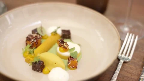 Plated Dessert with Mango Cream and Chocolate Crumble, Wooden Table, Overhead Stock Footage 341344841