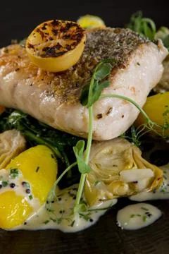 Plated fish cod loin main meal Stock Photos