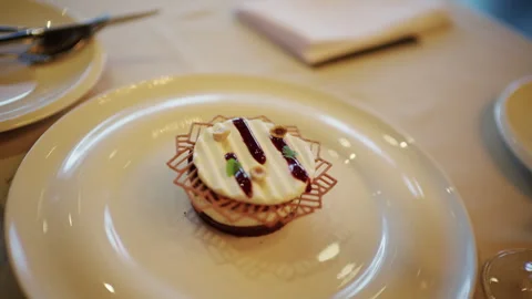 Plated gourmet dessert featuring a round mousse or cheesecake base topped with Vidéo 335229789