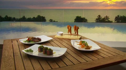 Plated meal near infinity pool Stock Footage 55571629