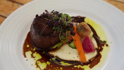 Plated steak dinner on table at restaurant chef kitchen food cooking Stock Footage 246703270