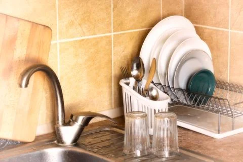 Plates and Cutlery Drying in the Rack Fotos de archivo
