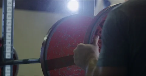 Plates being added to weightlifting bar close up Stock Footage 113683948
