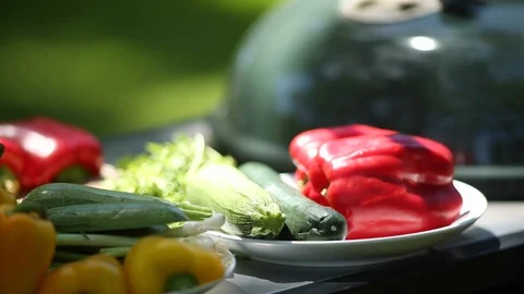 Plates of bright raw vegetables on a table outside. 스톡 동영상 88406640