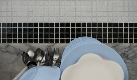 Plates on drying board at the kitchen Stock Photos