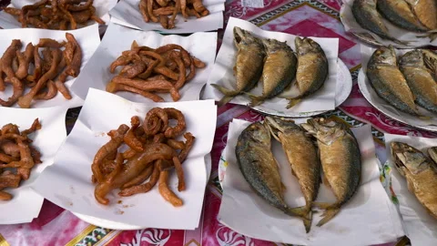 Plates with fried mackerel fish, pork slices, Omelet and Eggplant Thailand food Stock Footage 161965142