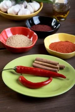 Plates with spices on an old table Stock Photos