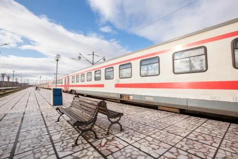 Platform with bench and train at the train station 스톡 사진
