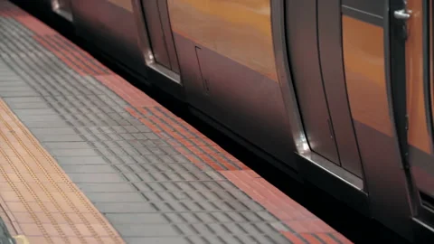 Platform gap close up as commuter train depart station. May cause serious hazard Stock Footage 219374205