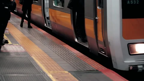 Platform gap close up as commuter train arrive and passenger get off and board Video stock 219374336
