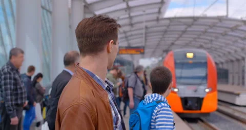The platform of the ground station of the metro is full of passengers and the tr Stock Footage 119632388
