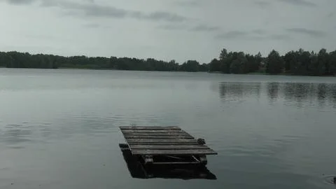 A platform on a lake surrounded by woods Stock Photos