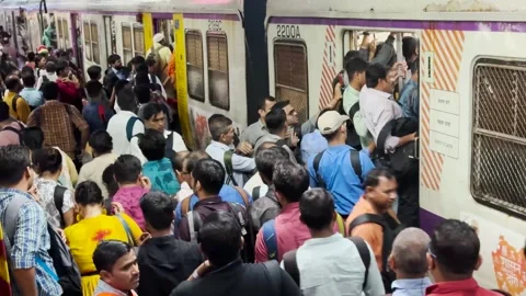 Platform packed with people train arrives, Crowd move to board train. 4K Stock Footage 249667115