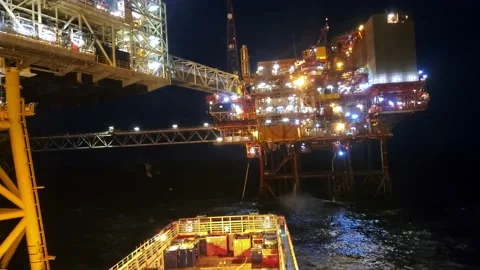 Platform supply vessel PSV during dynamic positioning DP operations near Oil Rig Video stock 166979017