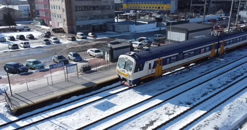 Platform where trains arrive. Flying over passenger train standing near platform Stock Footage 222961988